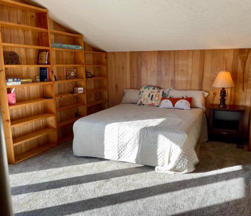 a bedroom with a bed and wooden walls at Lodges at Buffalo Mountain- 168 private acres in Floyd
