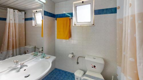 a bathroom with a white sink and a toilet at Dedalos Beach Hotel in Sfakaki