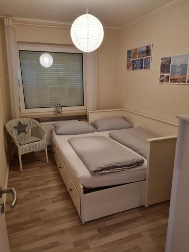 a bedroom with two beds and a window at Ferienwohnung Nordseetraum in Hage