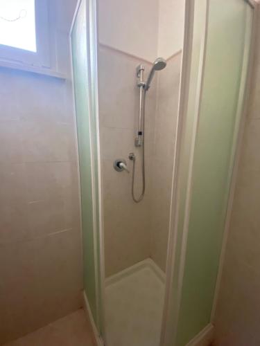 a shower in a bathroom with a glass door at Casale Colle dei Pini in Casaccia