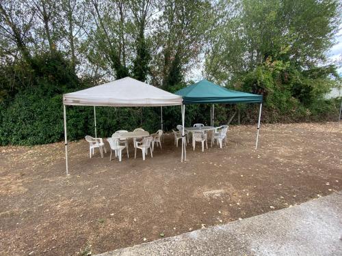 a group of tables and chairs under a tent at Casale Colle dei Pini in Casaccia