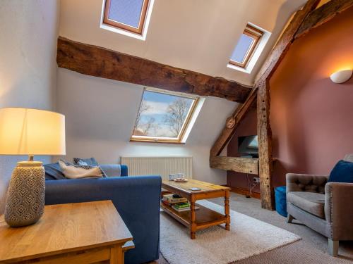 a living room with a blue couch and a table at Quaint 1 bedroom cottage in Church Stretton - Pass the Keys in Church Stretton