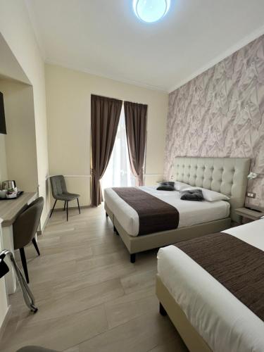 Hotel Le Petit tesisinde bir odada yatak veya yataklar
