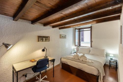 a bedroom with a bed and a desk and a chair at Ciambella Terrace-Rental in Rome in Rome