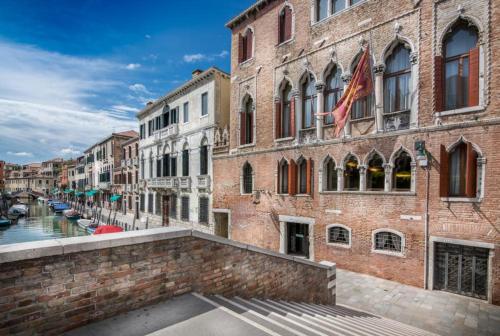 a view of a canal in a city with buildings at Palazzo Marcello Hotel Al Sole in Venice