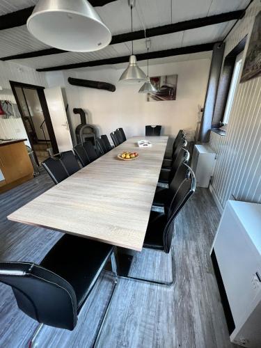 a conference room with a long table and black chairs at Haus Bornstein in Olsberg