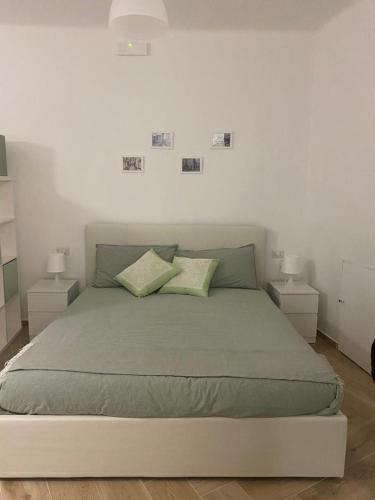 a bedroom with a large bed with two night stands at Antica noci in Noci