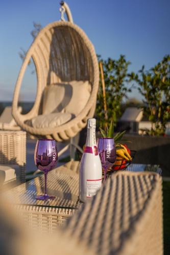 a table with two glasses and a bottle of wine at D-Palace-Lux in Donji Zemunik