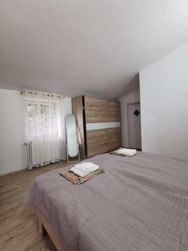 a bedroom with a large bed with two towels on it at Nikol in Karlovac