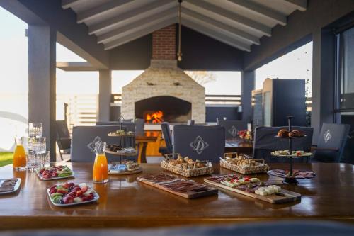 a table with food on it with a fireplace at D-Palace Apartments-Olive tree in Donji Zemunik