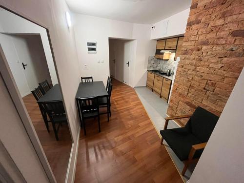 a dining room and kitchen with a table and chairs at Hostel WOKU in Świebodzice