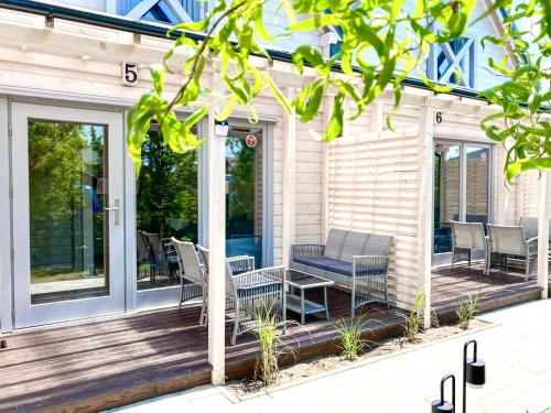 a screened porch with a table and chairs on it at LABALAND in Gąski