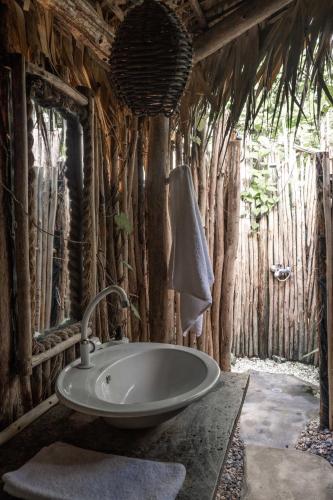 a bathroom with a sink and some trees at La Colmena RD in Santa Bárbara de Samaná