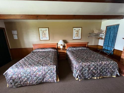 a hotel room with two beds in a room at Spinning Wheel Motel in Baraboo