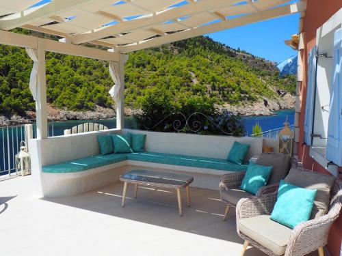 a patio with a couch and chairs and a table at AssosView in Asos