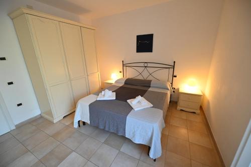 a bedroom with a bed with two towels on it at Aba Village RTA in Puntone di Scarlino