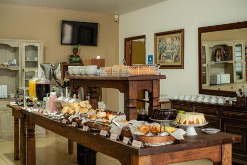 a buffet of food on a table in a room at Pousada Mirante das Estancias in Águas de Lindóia