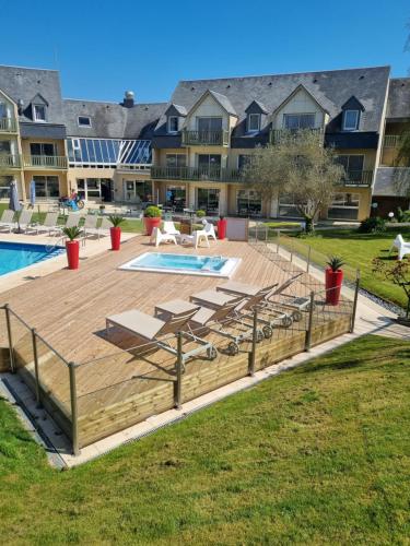 a deck with a pool at a resort at Appart Omaha Beach in Port-en-Bessin-Huppain