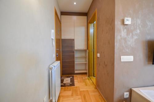 a room with a hallway with a door and a kitchen at Oaza in Zlatibor