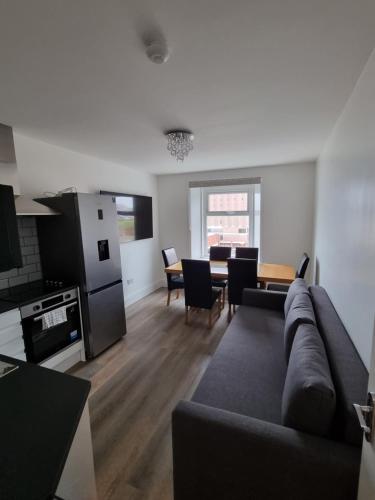 a living room with a couch and a dining room at Granada Apartments Derby Road in Blackpool