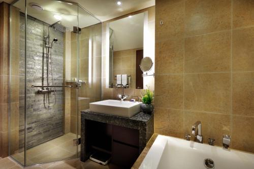 a bathroom with a sink and a shower and a tub at Intercontinental Alpensia Pyeongchang Resort, an IHG Hotel in Pyeongchang