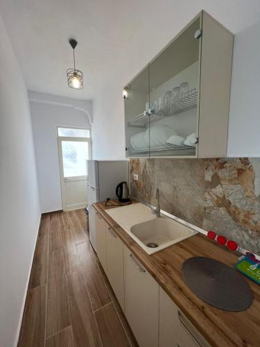 a kitchen with a sink and a counter top at Perdja Apartment II in Velipojë