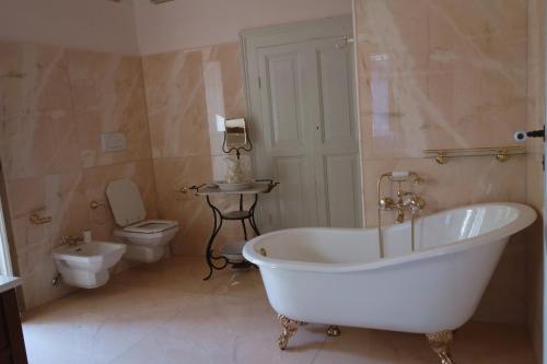 a bathroom with a white bath tub and a toilet at Antica Dimora Fuori Le Mura B&B in Scanno
