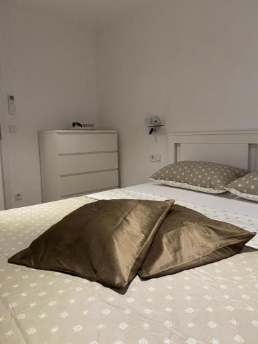 a gold pillow on a bed in a bedroom at The House in Medulin