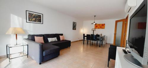 a living room with a couch and a table at Ria Formosa Beach Apartment in Cabanas de Tavira