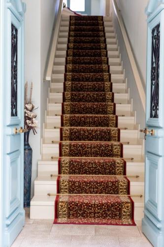 a stairway with a carpet on it at 999 Luxury Hotel in Nafplio