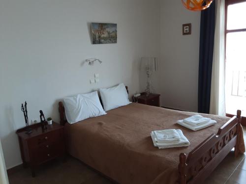 a bedroom with a bed with two towels on it at Remezzo in Mochlos