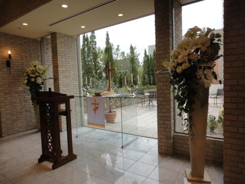 a church with a cross and flowers in a room at Mito Keisei Hotel in Mito