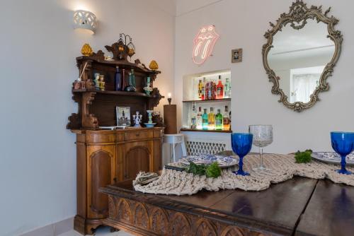 a dining room with a table and a mirror at CasaMia Positano - sea view and private outdoor hot tub in Positano