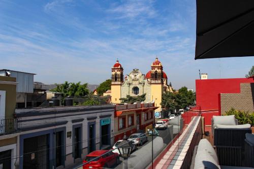 a view of a city with a building with a clock tower at Casa Naila Hotel Boutique in Oaxaca City