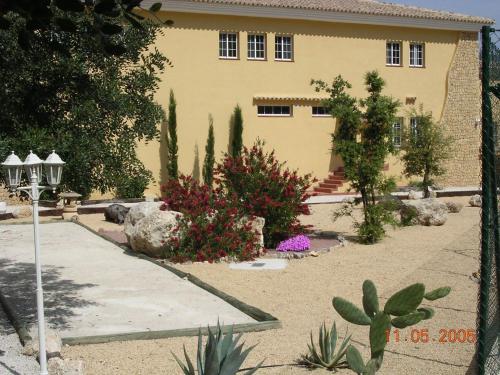 a yellow house with plants in front of it at Hotel Villa Lehmi in Tárbena