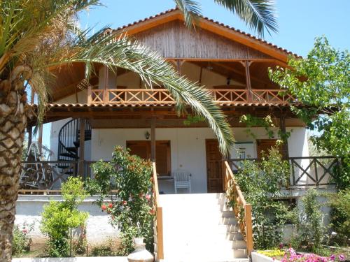a house with a palm tree in front of it at Villa Anta in Skala Kallirakhis