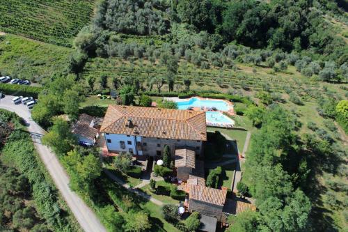 an aerial view of a house with a swimming pool at Borgo La Casaccia in Montaione