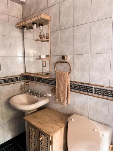 a bathroom with a toilet and a sink at Casa Moreno in Belén de Escobar