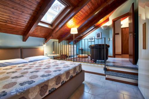 a bedroom with a large bed and a bathroom at Bella Omegna Apartments in Omegna