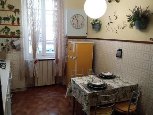 a kitchen with a table and a yellow refrigerator at tita's house in Lucca