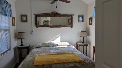a bedroom with a bed and a mirror on the wall at Apple Place Room #1 in Miramonte