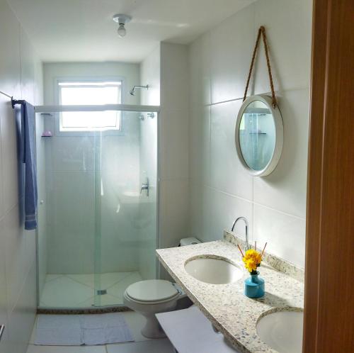 a bathroom with a shower and a sink and a toilet at Beach house - secured, beach access, sea view, best location in Baixio