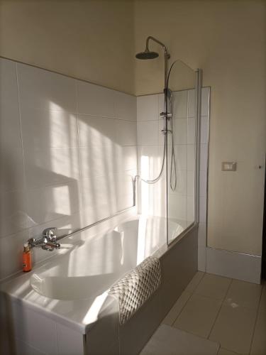 a white bathroom with a sink and a shower at Casale Il Girasole in San Costanzo