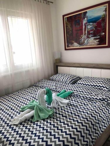a bedroom with two stuffed animals on a bed at Tri palme in Banja Koviljača