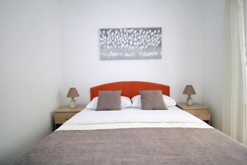 a bedroom with a large bed with two night stands at Apartments Miovic in Molunat