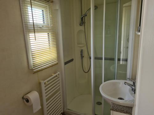 a bathroom with a shower and a sink at 6 Berth central heated on Golden Sands Vintage in Ingoldmells