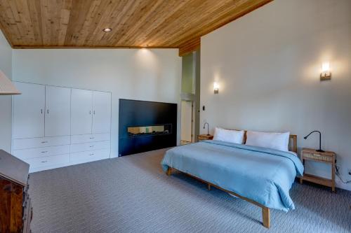 a bedroom with a large bed and a fireplace at Mountain & Lake-View Delight in Truckee
