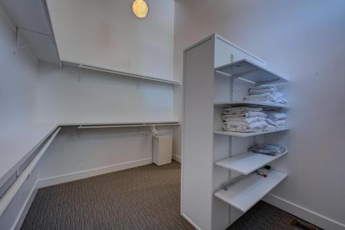 a white closet with white shelves and towels at Mountain & Lake-View Delight in Truckee