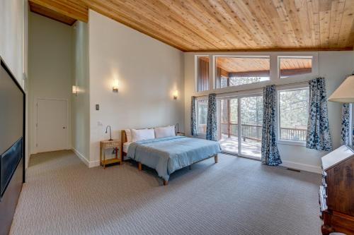 a bedroom with a bed and a large window at Mountain & Lake-View Delight in Truckee