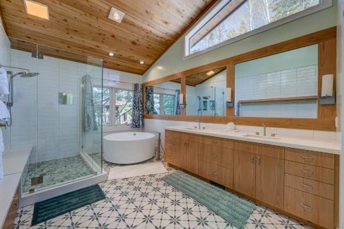 a bathroom with a tub and a shower and a sink at Mountain & Lake-View Delight in Truckee